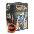 The front of the Bones Coffee Company Churro 12 Count Bones Cups box. Its flavor is churro, and it has a skeleton in front of a churro stand holding out churros on the art.