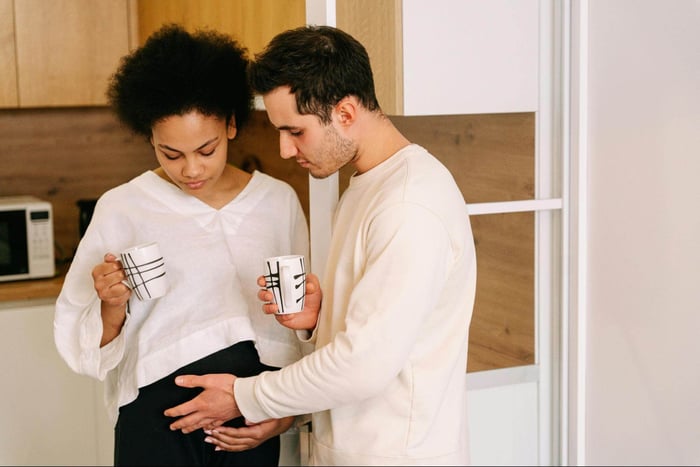 pregnant wife and husband drinking coffee