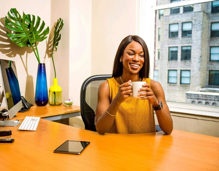 woman drinking coffee while working