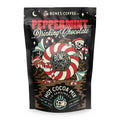 A bag of drinking chocolate mix that has peppermint in it. The art has a skeleton and reindeer wearing a santa clause cap hiding behind a giant peppermint circle.