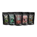 There are five four-ounce bags of coffee from Bones Coffee Company. From left to right their names are Bananas Foster, Mint Invaders from Chocolate Space, White Russian, Strawberry Cheesecake, and Maple Bacon.